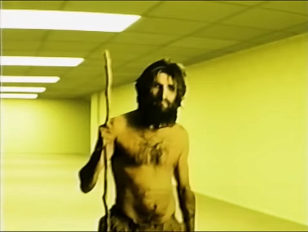 KaneHypeGuy's tweet photo. The figure in the hallway of the Backrooms trailer appears to be a Caveman cutout very similar to the one featured in Found Footage #3. https://t.co/xqXfI4Clms