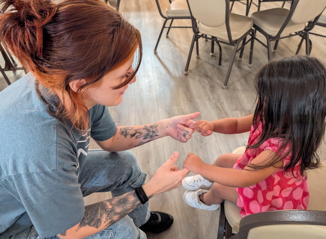 Shelter manager Juliana has a fun conversation with one of our younger guests.