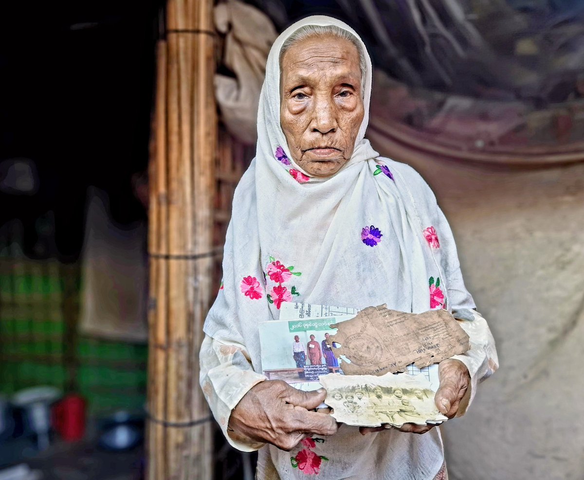 tg_azimullah's tweet photo. Sufiya Khatun, 103, a Rohingya woman displaced in 1978, 1992 &amp; 2017, now lives in Cox’s Bazar.

In 2017, her image reached the world.
“I was hungry and thirsty… I saw a photographer taking pictures,"

Her documents and a 1978 family photo prove a life once lived—her identity. https://t.co/45Dc4OpjDb