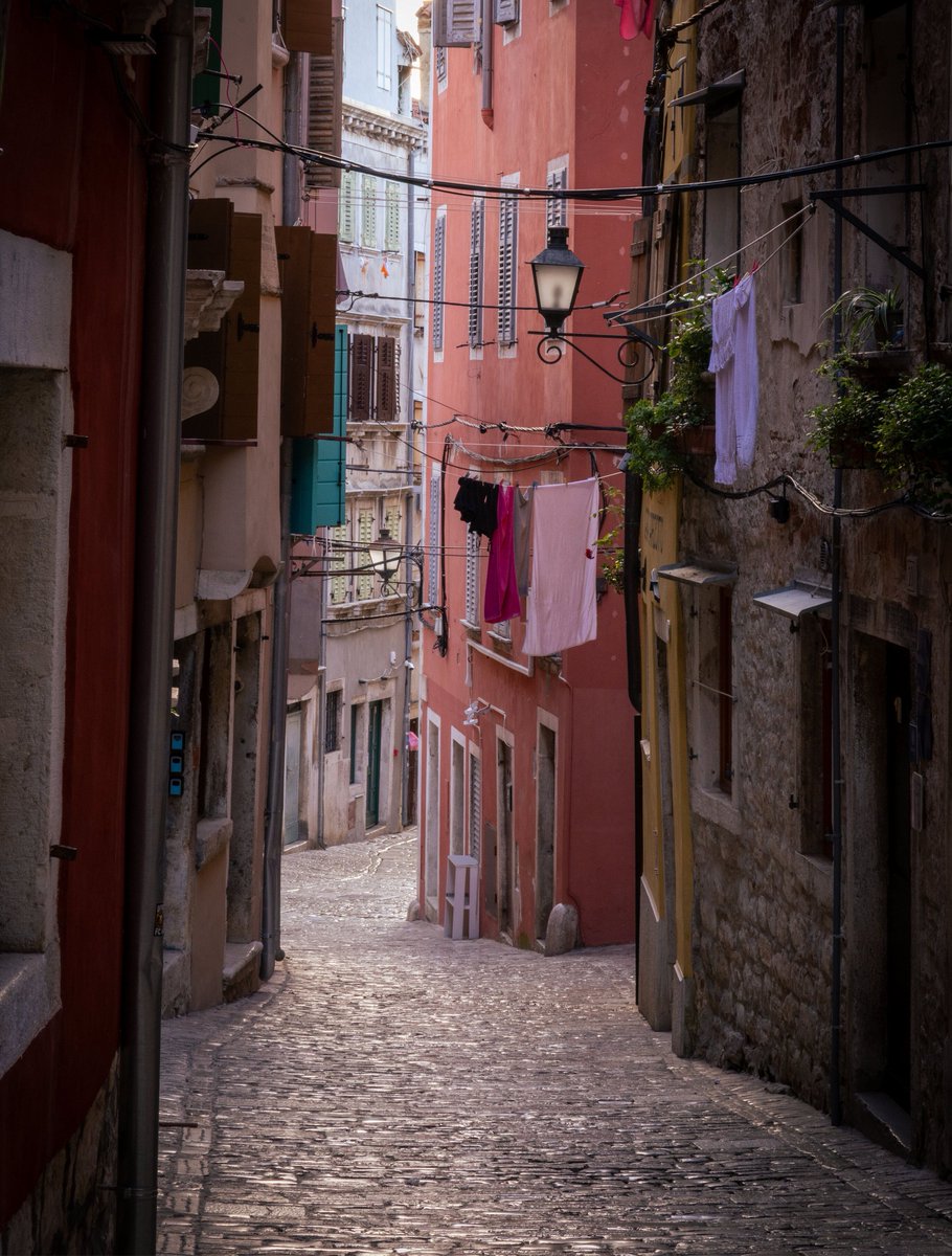Laundry hanging above a narrow street in Rovinj, Croatia.