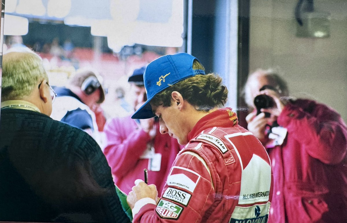 HRiddler's tweet photo. Some photos @McLaren of the late, great Ayrton Senna signing a @TAGHeuer cap at @SilverstoneUK for my dad. He was kind enough to give him his ear plugs too, straight out of his ears! An absolute gentleman. #formula1 #mclaren #ayrtonsenna #silverstone #silverstonegp https://t.co/aTUDxeG5Py