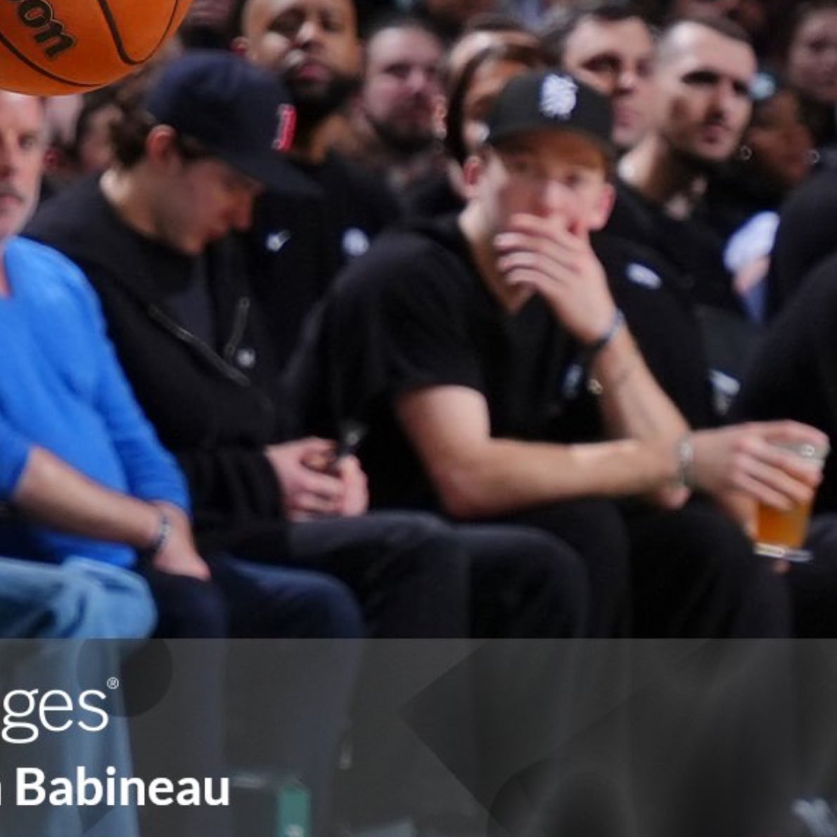 fraser minten spotted on his phone at celtics game while mason lohrei is watching intensely