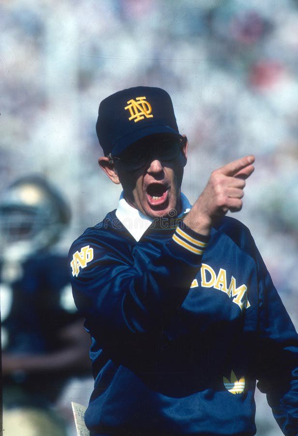 squinn34's tweet photo. I propose that we pick a home @NDFootball game this season (Stanford) and we all dress up like Lou Holtz- navy hat with an ND logo, white collar shirt and navy sweatshirt with Notre Dame across the chest. It'd be a great gesture to honor him. ☘️ @NDFootballPR @NotreDame https://t.co/eGrJACHYtv
