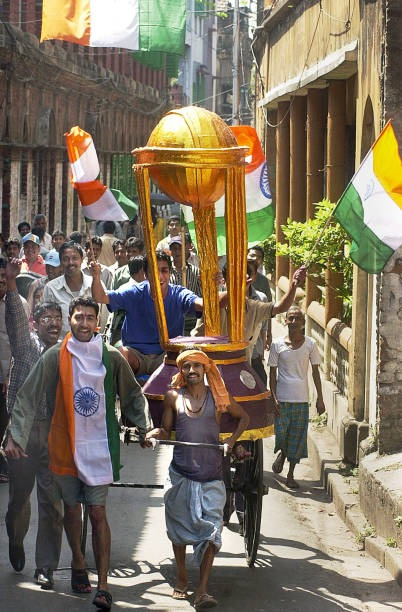 TMCinHistory's tweet photo. 🕒 2003

On this day of 23rd March in 2003, cricket fans in Kolkata carried national flags and a replica of the World Cup trophy through the streets, showing support for India ahead of the World Cup final against Australia. https://t.co/mILaSxFLCx
