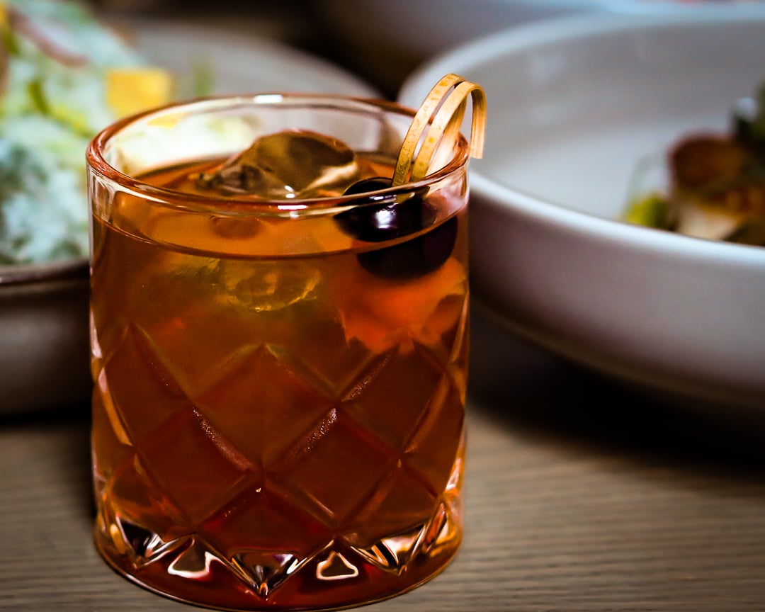Raise a glass to the crowd favorite - The Franklin Room Old Fashioned! 🥃🍒 Savor every sip of this classic blend, featuring Angel's Envy rye, Angostura, Peychaud's with a twist of orange saffron, cherry bark vanilla &amp; Demerara. #OldFashionedLove #SignatureSip #TheFranklinRoom