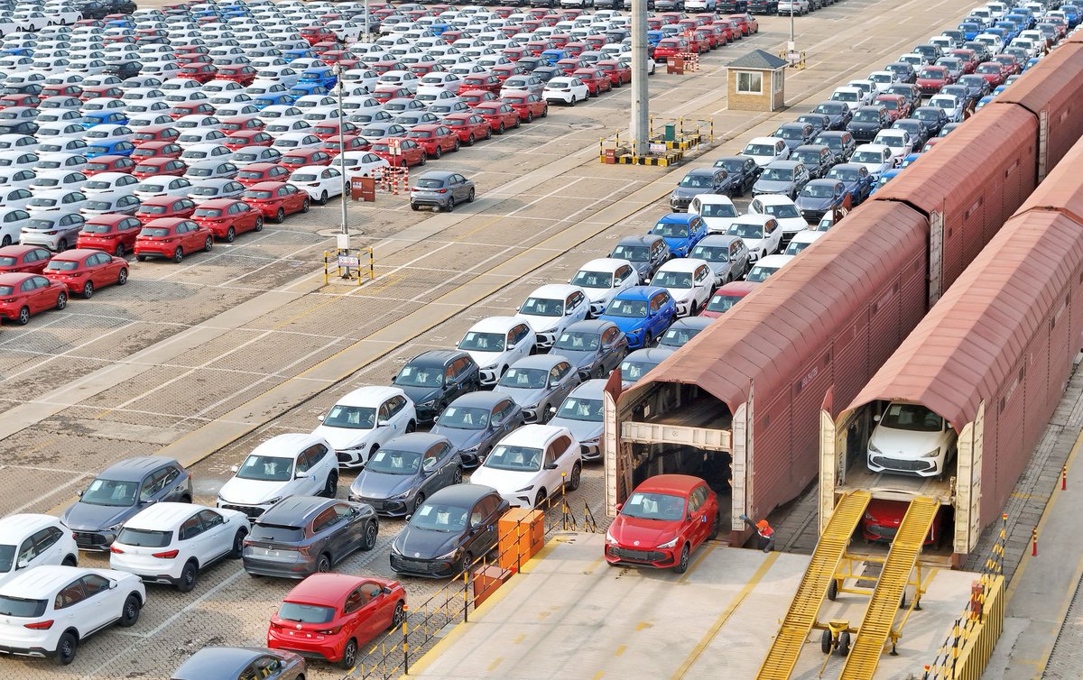 At Yantai Port in Shandong, Chinese-made vehicles are driven off freight trains for export.