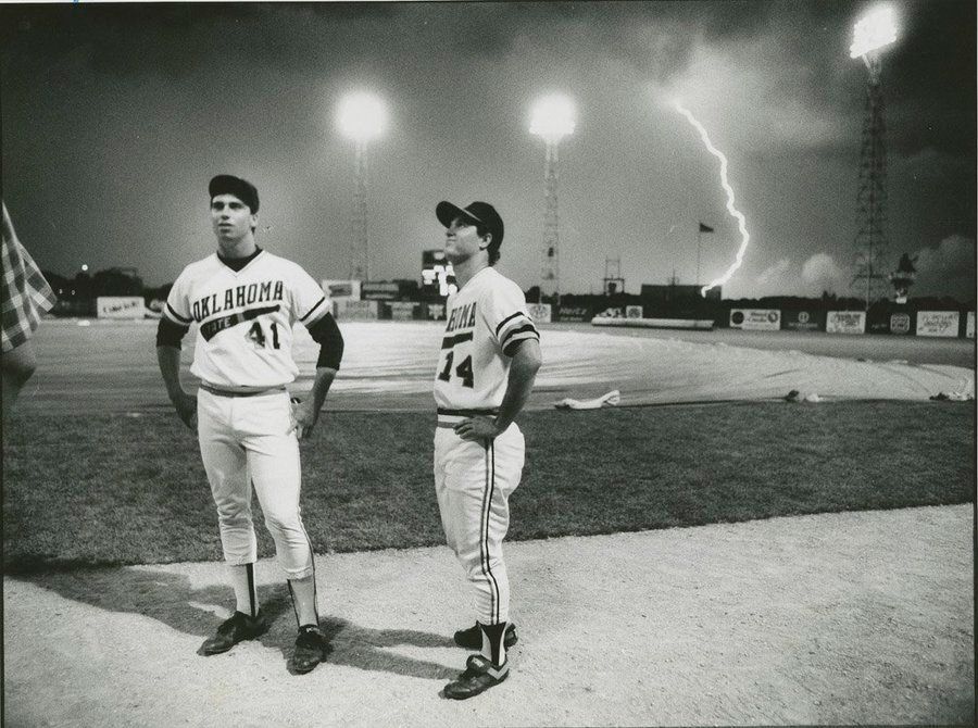 Lightning strikes behind Oklahoma State players during a rain delay at the College World Series, 1987. Oklahoma State would finish runner up in the series.