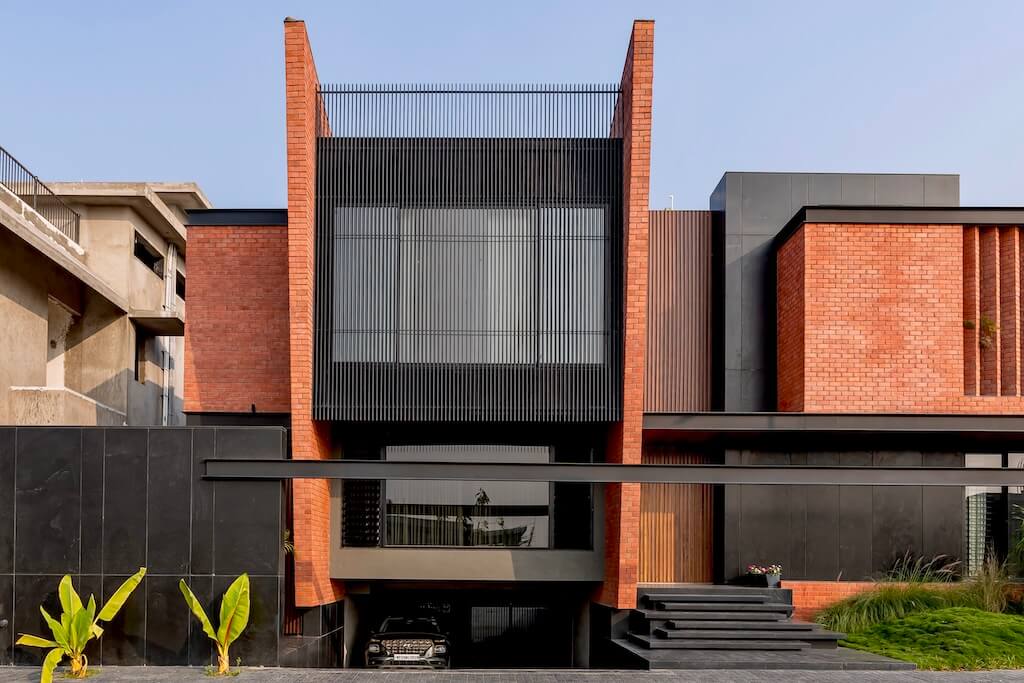 crystal_kizor's tweet photo. This home could have been built with concrete.
But brick was chosen.

And that decision changed everything.

Here’s what makes this house stand out:

1. Brick as identity, not just structure
The material is not hidden.
No paint. No cladding.
Just brick, shaping the entire expression of the home.

2. Depth, not flat walls
The walls are not just surfaces.
They are angled, project, recess.
Creating shadows, reducing heat gain, and giving the building a strong presence.

3. A controlled use of black
Black is used carefully.
Not everywhere. Not excessively.
Just enough to create contrast and allow the brick to stand out.

4. Brick beyond walls
Brick is used on ceilings too.
Vaulted, textured, continuous.
Turning the space into an experience.

5. Light as a design tool
Openings are intentional.
Soft daylight enters where needed.
Highlighting textures, guiding movement, shaping mood.

6. Green as balance
The landscaping is not decoration.
It softens the building, cools the surroundings, and completes the experience. 
Though it is a small site, 80% of its space was given to greenery 

This is what happens when a material is respected.
Not covered. Not replaced. Not apologised for.
Architecture begins to feel grounded.

Add yours. What makes this home stand out to you?

📍 Indore, India
Project: The Brick Home
Design: Abhishek Ajmera Architects
Photography: Inclined Studio