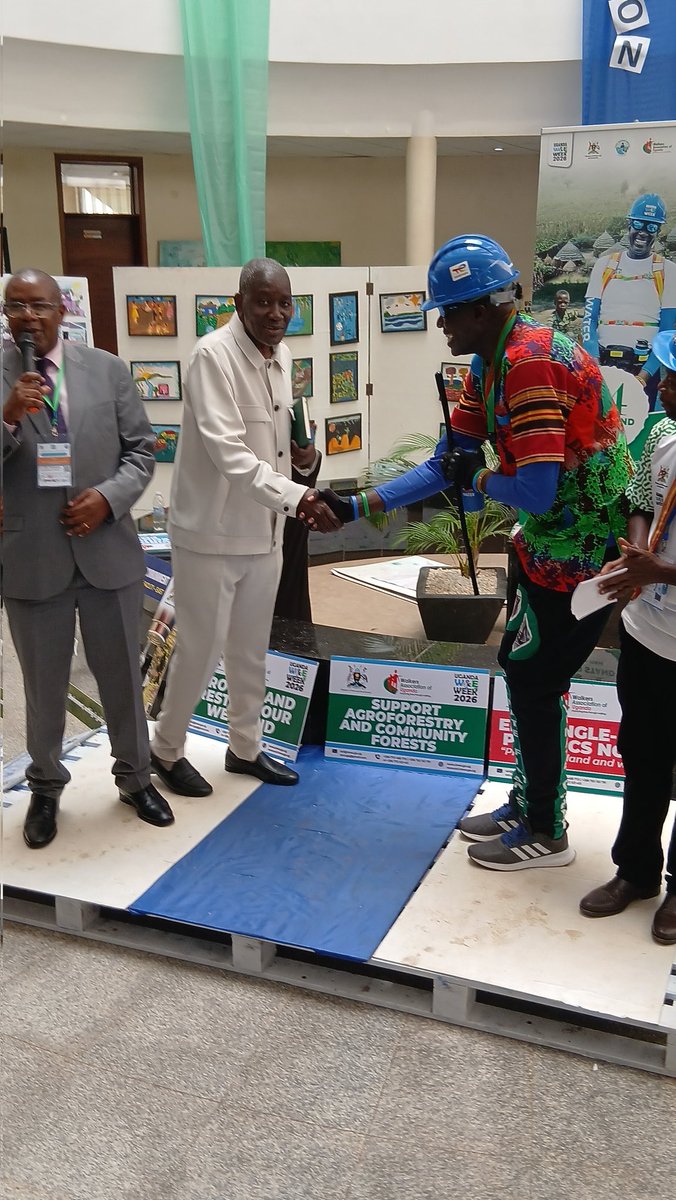 JumbeBenjamin's tweet photo. Permanent Secretary Alfred Okidi applauds Geoffrey Walker Ayeni for completing a 24-hour standing challenge to raise awareness on clean water access in Karamoja.

A powerful moment during Uganda Water and Environment Week. #WaterForAll
@min_waterUg
@UgandaWalkers https://t.co/3Jq6jMzzyY