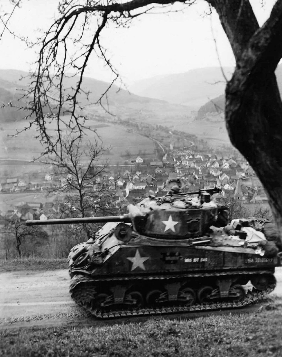 TheWorldatWar2's tweet image. A US M4A3 Sherman tank belonging to the 12th Armoured Division heads past the small town of Schneeberg, Germany - 1945 #schneeberg #germany #usarmy #tank #sherman #shermantank