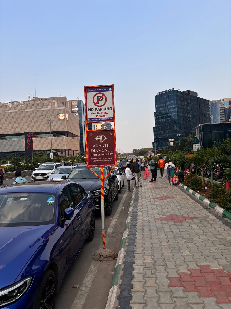 kaverip's tweet photo. @CYBTRAFFICI would like to report Parking violation and Kiosk created by Cafe Niloufer in Orbit Building in Raidurgam. Cafe Niloufer provides Valet parking service where  these  vehicles  cover 3/4 of the road which creates traffic congestion for others . Also  this is designated as No parking area for 100mts and no-parking board, they park the vehicles and also claim that they have permission from traffic police. 
please confirm if its correct that they have  permission to park the cars in no parking area?. if not why  traffic police closed there eyes here and not taking any action