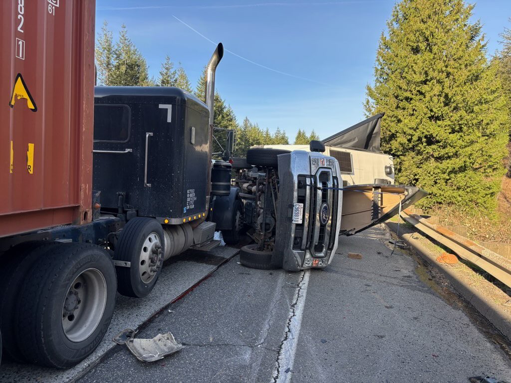 wspd2pio's tweet photo. #Blocking NON-injury collision WB 90 near MP 27. A car merged into a semi forcing it over where it struck this truck and trailer. Right two lanes blocked for tow trucks to clear the scene.  Use caution through the area. https://t.co/6lepy73YWF