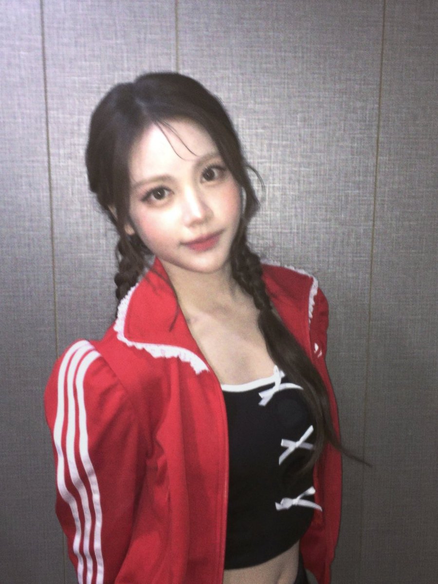 red jacket with structured lines and stripes, layered over a delicate black top with tiny ribbon details. it’s strong and feminine at the same time like mixing energy with softness. the silhouette feels more defined here, more styled, but still not too heavy.