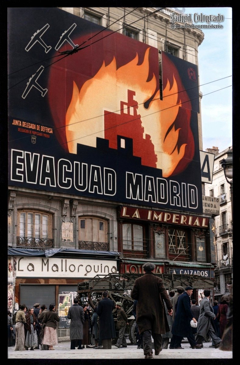 MadridColoreado's tweet photo. La Puerta del Sol durante la Guerra Civil, hacia 1937. Un mensaje urgente en la ciudad bajo las bombas: “Evacuad Madrid”.
Miles de personas abandonaban la ciudad sin saber si volverían.
🎨 Foto restaurada y coloreada por @madridcoloreado. https://t.co/b5ul27Xpe9