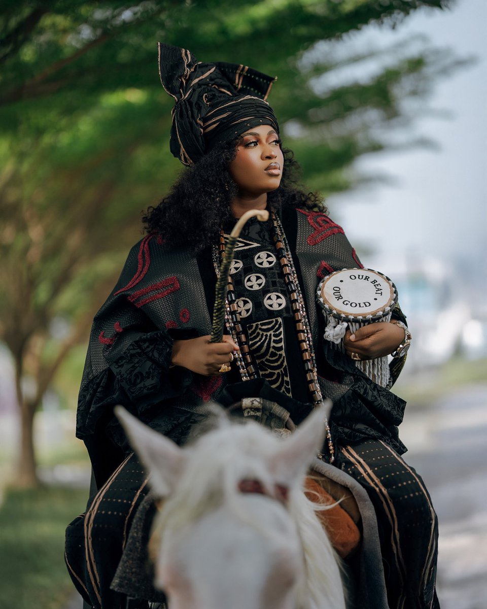 Imisioluwa Opeyemi “Ayanwale” <a href="/imisiofficial/">IMISIOLUWA🧡</a> 

In case you're wondering she's carrying the talking drum, she's a daughter of Ayan (Talking Drummer). 

Omo Oba Ni E