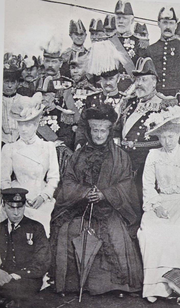 Long after her fall from power, former empress Eugénie remained friendly with the British royal family. Here she is pictured with a (surly and sitting) future king, Edward VIII, and a current one, Edward VII (behind to the right) at a naval review.