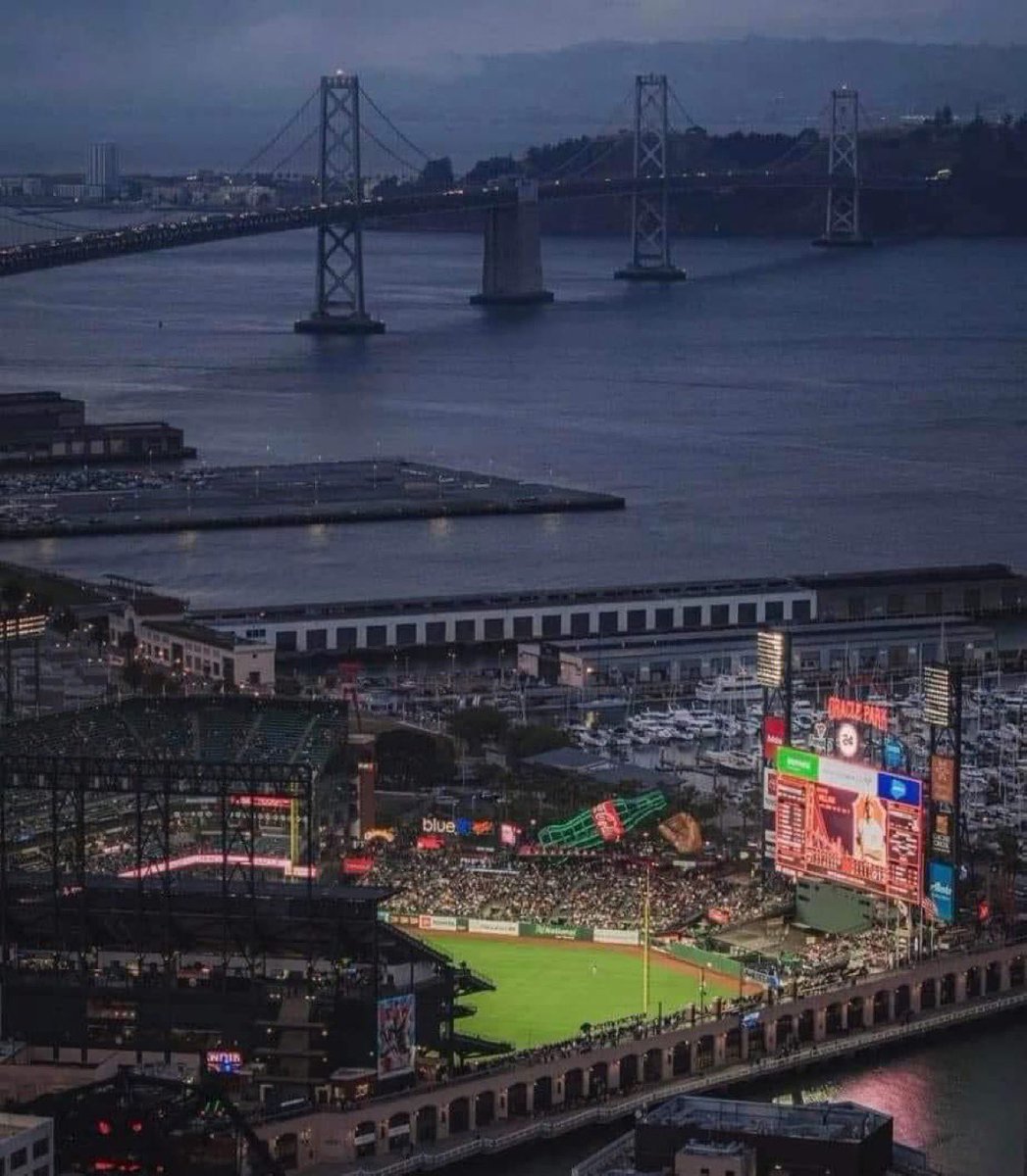 Oracle Park with the Bay Bridge and San Francisco Bay in the background.