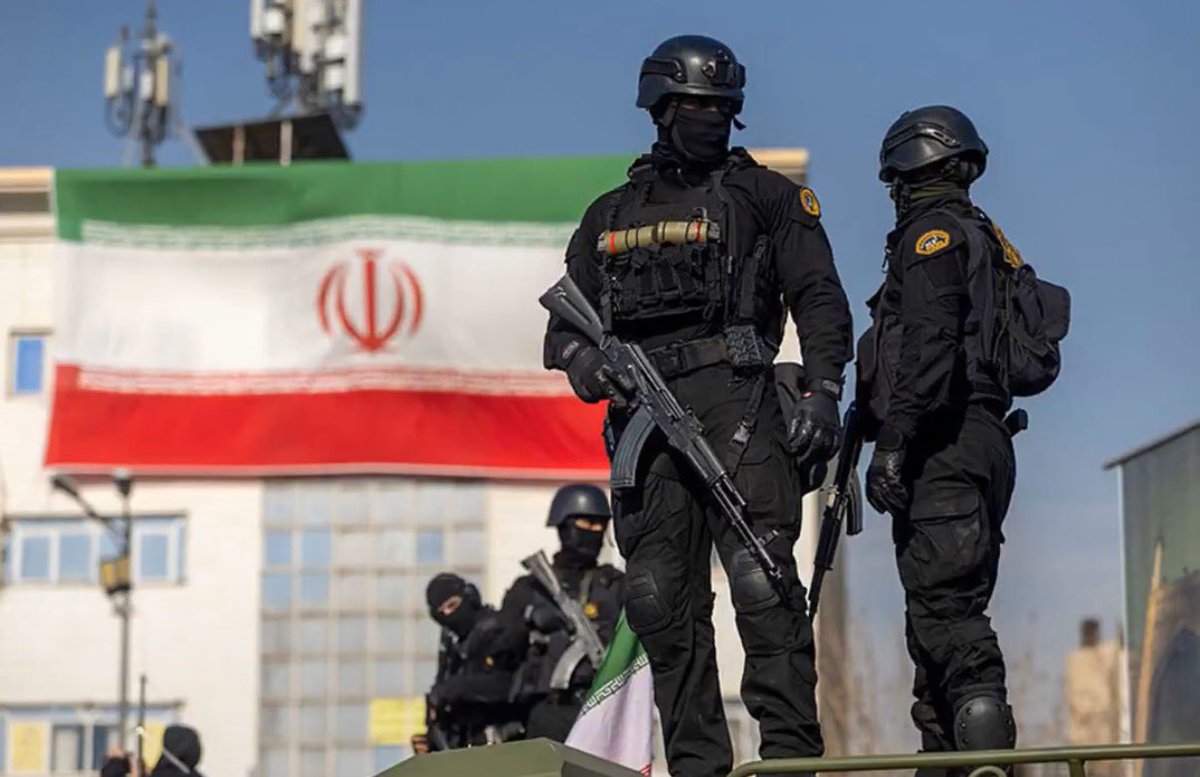 goarider's tweet photo. Foreign Ministry Spokesman Saeed Khatibzadeh (leaning forward, smirking):  
And they will leave at our will.  
Every single one of them.  
Whether they march out on their own boots… or get shipped home in body bags.  
That choice belongs to the Islamic Republic of Iran, not to the Pentagon or the Zionist entity.