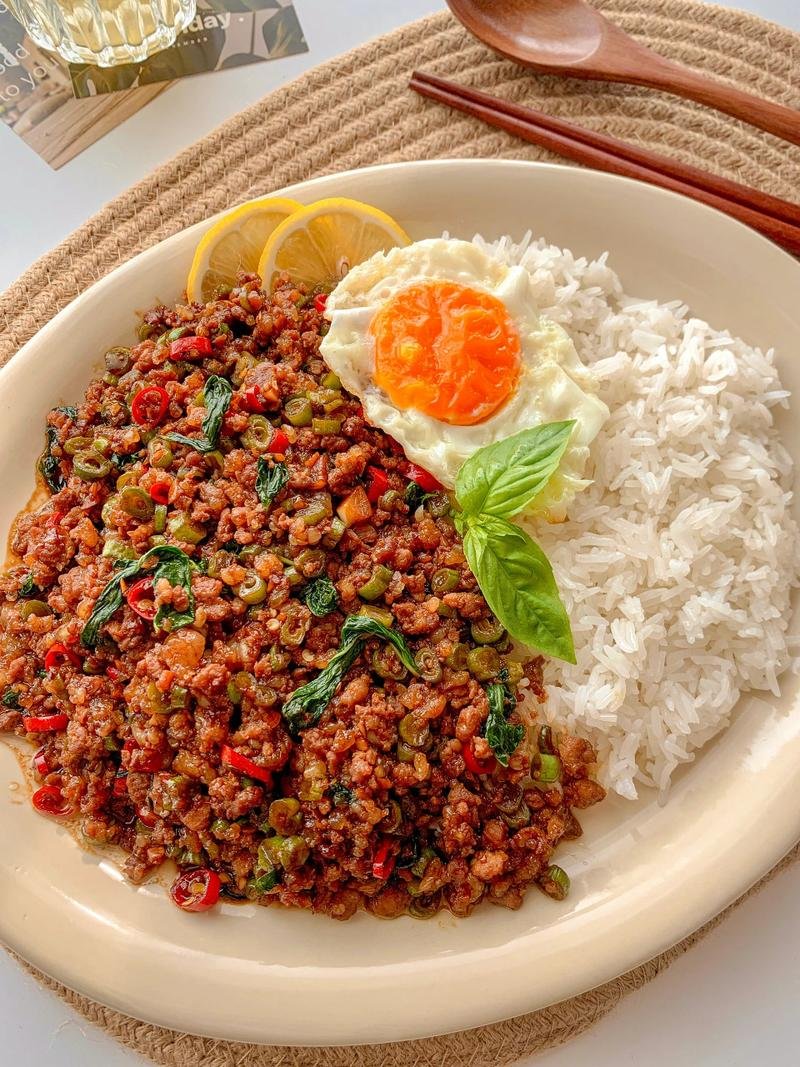 xoxonishinwa's tweet photo. Dive into Thai Basil Chicken (Pad Krapow Gai) – fragrant basil, tender chicken, u0026 spicy kick! Served with fluffy rice, it’s a flavor explosion in every bite. Who’s craving this tonight  #ThaiFood #PadKrapowGai #FoodieJoy https://t.co/AmyoMzVdGp