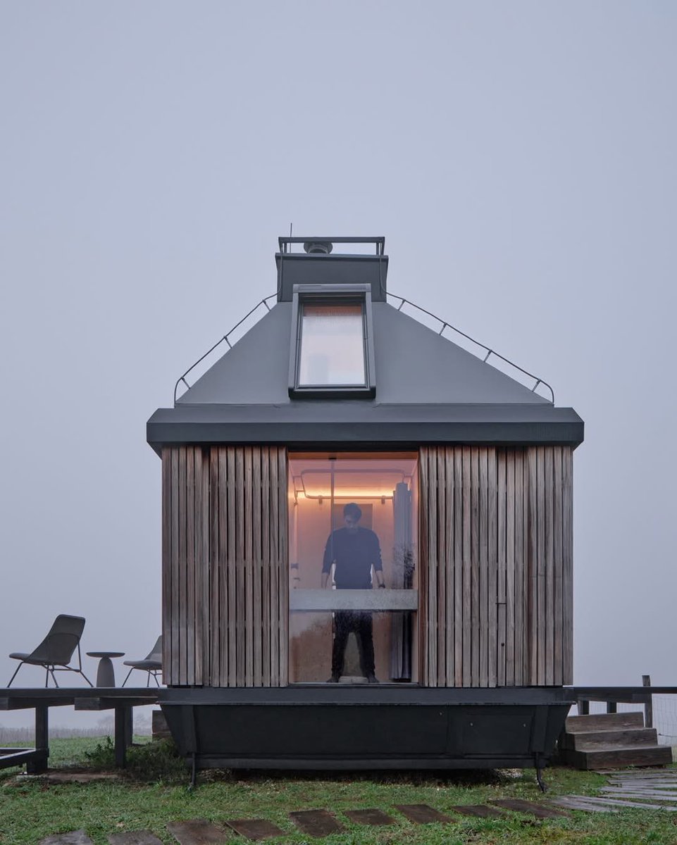 XekiHlongwane's tweet image. A shelter for a grey monday ☁️

in devín, #slovakia, archekta and ark-shelter work within 20sqm, but the cabin doesn’t really read as small. fold-down #facades shift it somewhere between shelter and landscape, opening the interior to air, light, and long vineyard views.