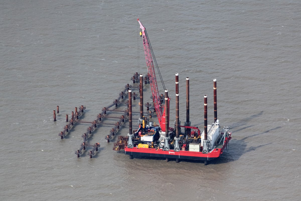 johnfielding001's tweet image. EXCALIBUR jack-up platform at Sizewell C, Suffolk (April 2026). Operated by DEME, installing piled foundations for offshore works. Fugro branding reflects seabed survey &amp;amp; ground investigation behind the build. Part of the £20bn+ project #Sizewell #aerial