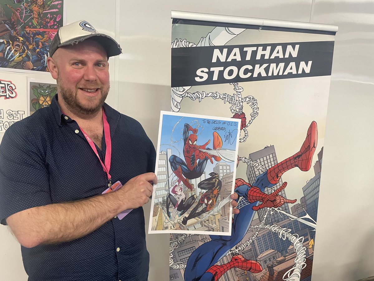 OLSComicClub's tweet photo. 💥 We were delighted to unveil a very special piece of art- a framed picture from @StockmanNate with the message “To the girls of OLS- CHEERS!” 

This picture will go pride of place in the Comic Book section of our Library, beside the great Batman art from @Clay_Mann_ @TomKingTK https://t.co/ouNrTTgev0