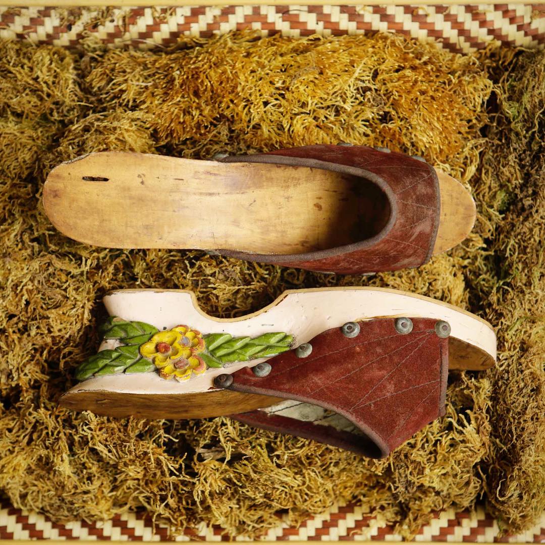 Bakya - Philippines, 1930s–1940s.

Bakyas are wooden clogs made from light wood such as santol and laniti. They are carved to the desired foot size, smoothed, and often decorated with floral and geometric designs, after which they may be painted or varnished.