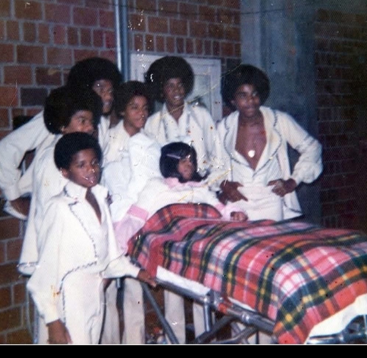 The Jacksons visiting a girl that was burned in a house fire.