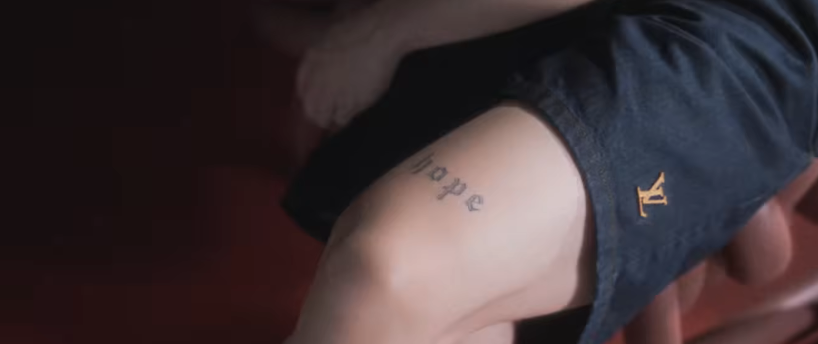 his 'hope' tattoo.