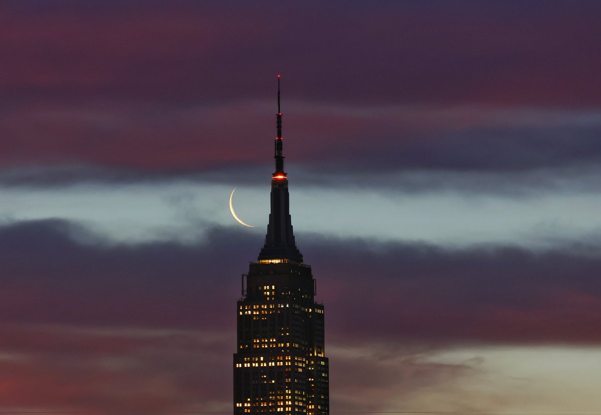 GaryHershorn's tweet image. A five percent illuminated waning crescent moon rises behind the Empire State Building as the sun rises in New York City, Wednesday morning #newyorkcity #nyc #newyork #moon #sunrise @empirestatebldg