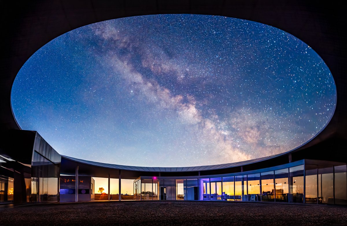 ChinaDaily's tweet image. The Milky Way arcs across the night #sky, perfectly framed by the circular structure known as the "Eye of Amyta" in Daqing, Heilongjiang province, on Monday, creating a surreal scene where sky and earth appear to meet. #space