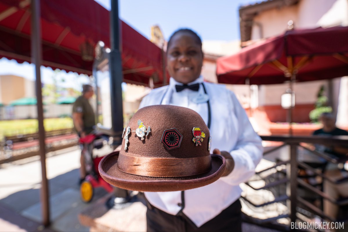 We interrupt your regularly scheduled programming to inform you that Cast Members are pin trading in front of The Brown Derby with a brown derby