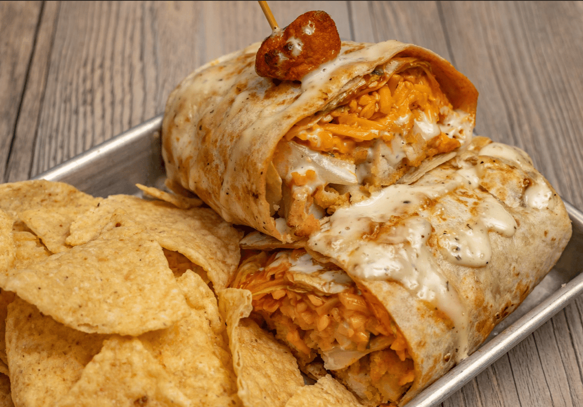Tables_Taps's tweet photo. Craving something delicious? Our Buffalo Ranch Chicken Wrap is a hit! With crispy chicken, ranch, buffalo sauce, romaine and Cheddar cheese. It's the talk of the town! Taste it to believe it! 😋🌯 #TablesAndTaps #WrapsToDieFor https://t.co/05o6PNF3H9