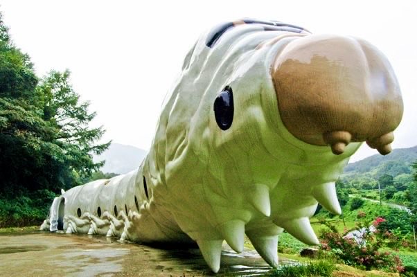 WeirdWhere's tweet image. This is a building shaped like a giant silkworm! It is located in South Korea and is part of a museum or exhibition space dedicated to insects and silk.

Cool Facts About the Building

• The Shape: It is designed to look exactly like a silkworm larva.

#art #worms #korea #museum
