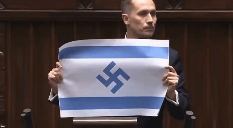 Heloise1688's tweet photo. Polish far-right MP Bekovic displayed a modified Israeli flag in a parliamentary speech, replacing the Star of David with the Nazi swastika and referring to Israel as the "New Third Reich," sparking intense controversy. https://t.co/4TCUfQGjex