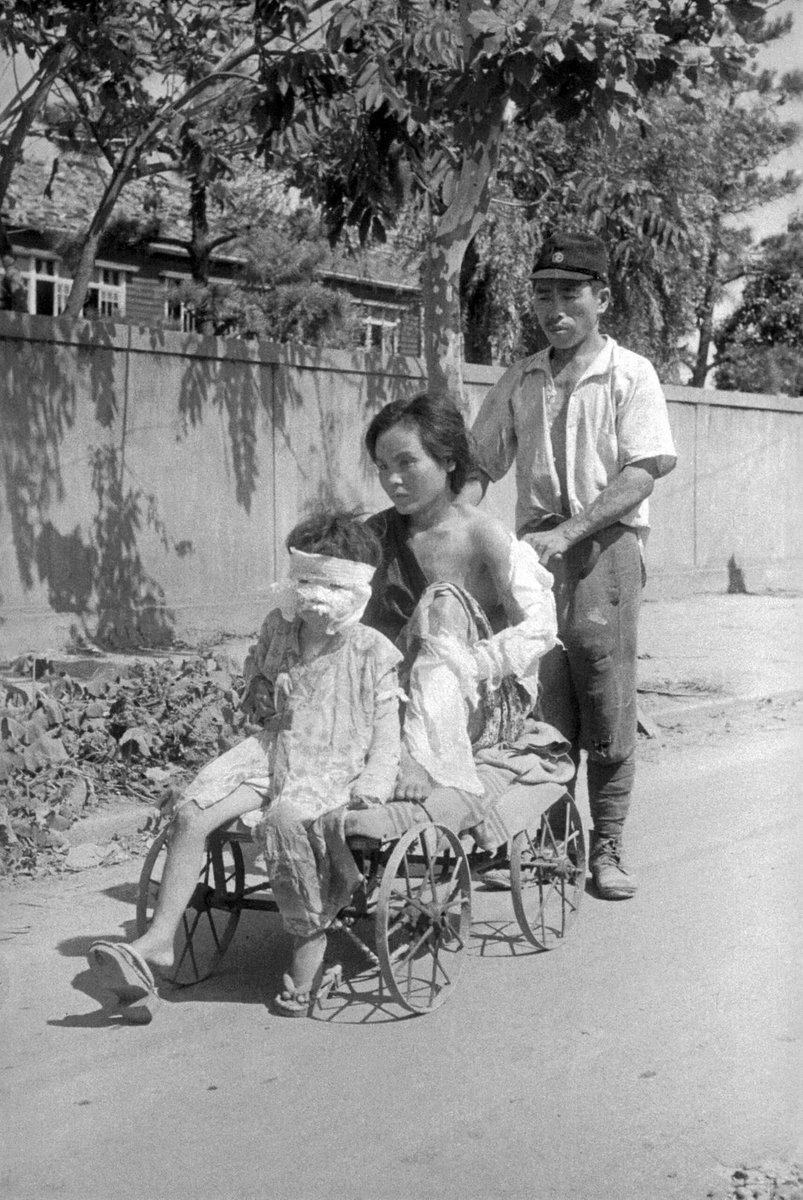 historydefined's tweet photo. Family going home after treatment, Hiroshima 1945. https://t.co/enBWEMmkll