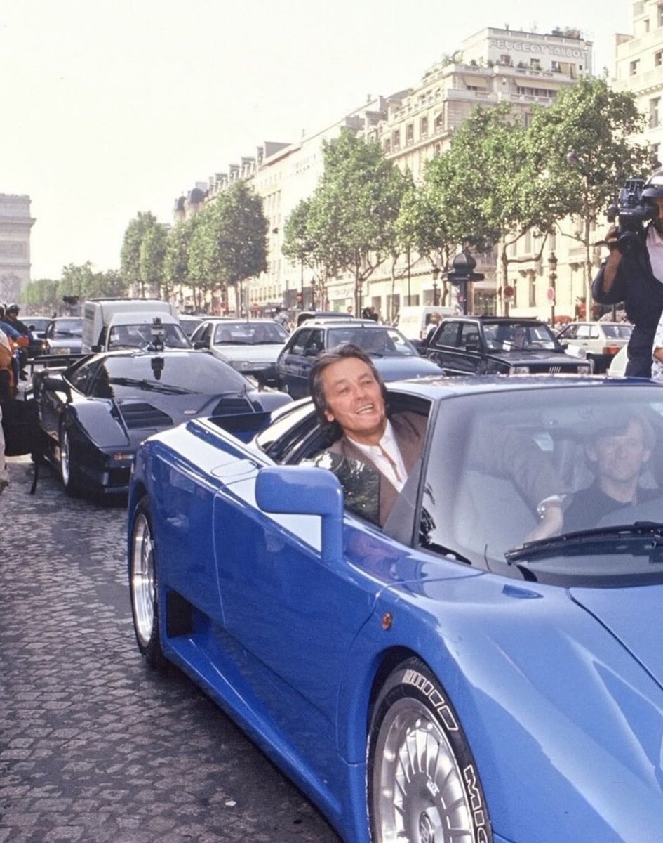CarSighting's tweet photo. I have to admit I had never noticed until today the presence of the EB110 prototype behind Alain Delon’s. I believe it is chassis 39001 https://t.co/ywfWSGeqsv