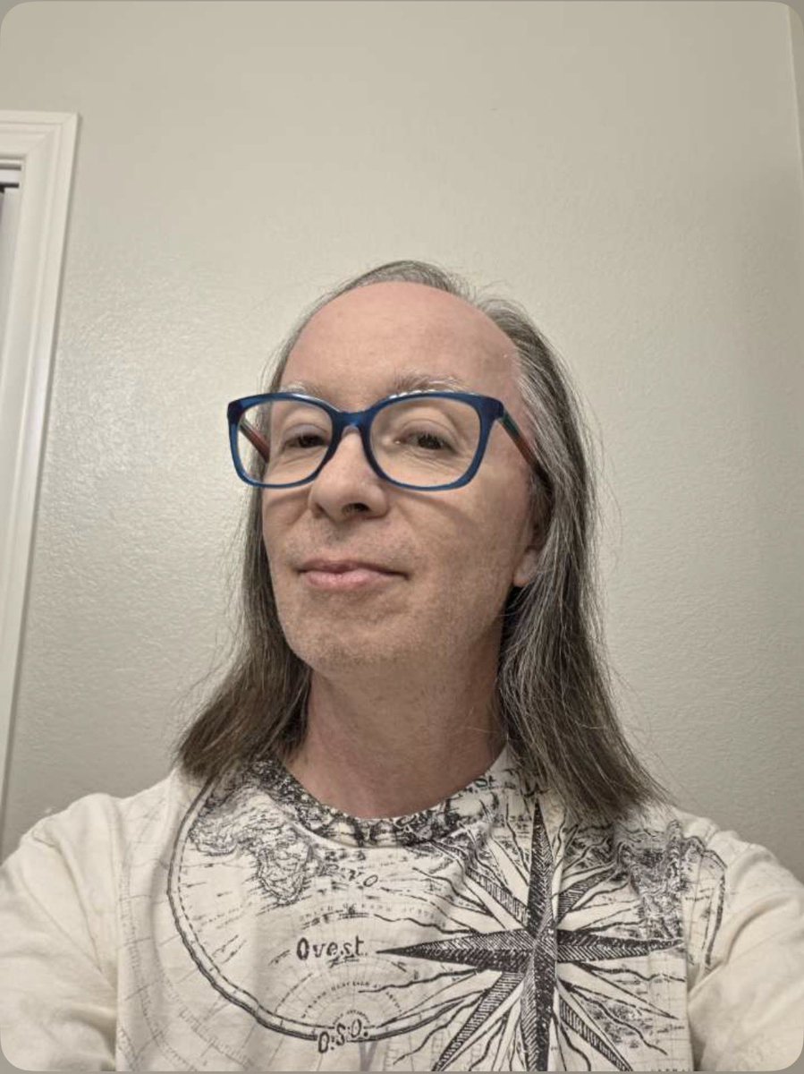 A picture of me today, April 3, 2026. No makeup, no wig, no hair dye, no jewelry, only glasses, just a t-shirt and pants. I earned every one of those gray and white hairs. #noelbenoit #MusicIsMyMantra #noël #sixtythreeandahalf #keepingitreal