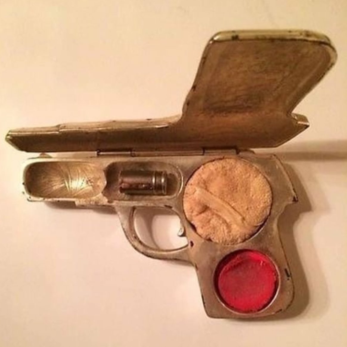 1920s makeup compact with powder, rouge and lipstick in the shape of a bullet