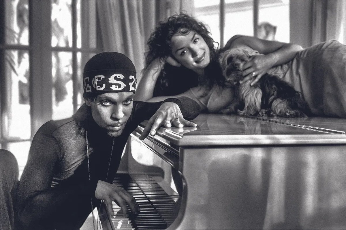 Baron3121's tweet image. Prince and Mayte at their home in Marbella, Spain

'Prince and Mayte with one of their dogs, Mia, posing on the piano. Mia was quite the trooper that day. I loved the light coming from all the windows and doors in this shot.'

(📸: © Steve Parke)
#NPG #PRINCE #PRINCE4EVER