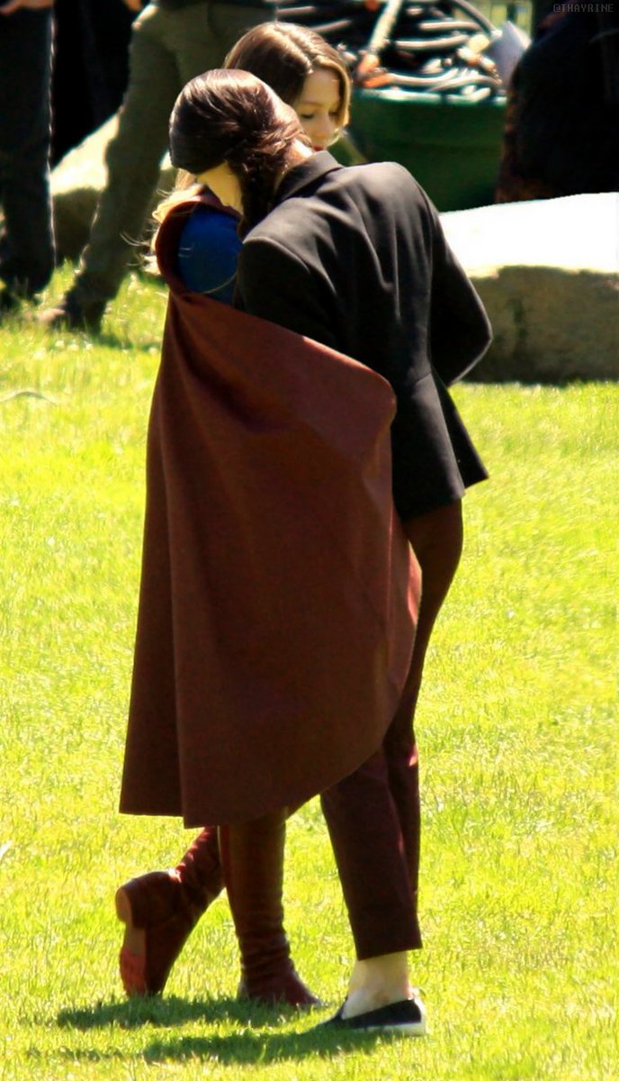 a baby wrapping her baby in her little cape