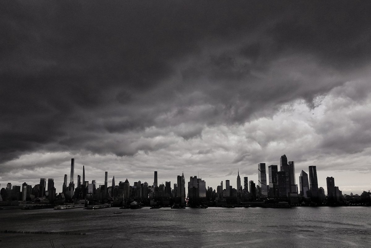 GaryHershorn's tweet image. Black clouds over midtown Manhattan at sunset in New York City, Sunday evening #newyorkcity #nyc #newyork #sunset