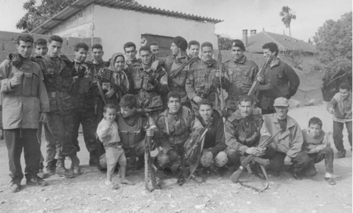 Civilian Algerian militia that was formed to defend their village against terrorists taking a family group photo where you can even see one of the combatants' mothers holding an AK-47.
