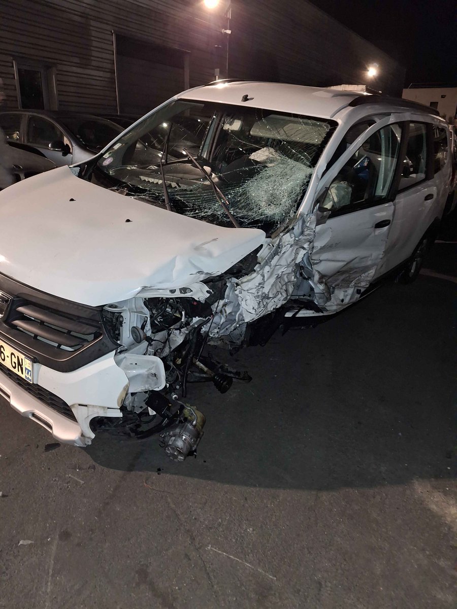 Update on the situation, we got a taxi back home and we're now safe and sound. Car is irreparable but somehow none of our luggage got damaged, and even though the cabin caved inwards there are only a couple bruises on us. An absolute miracle