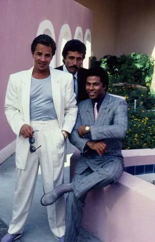 Chibi_Guyver's tweet photo. @saintseiyagod My guess would be Miami Vice (1984). Not in the picture, but the rolled up sleeves on the suit jacket is one of the fashion choices made popular by the show. https://t.co/rZq3vXhM5N