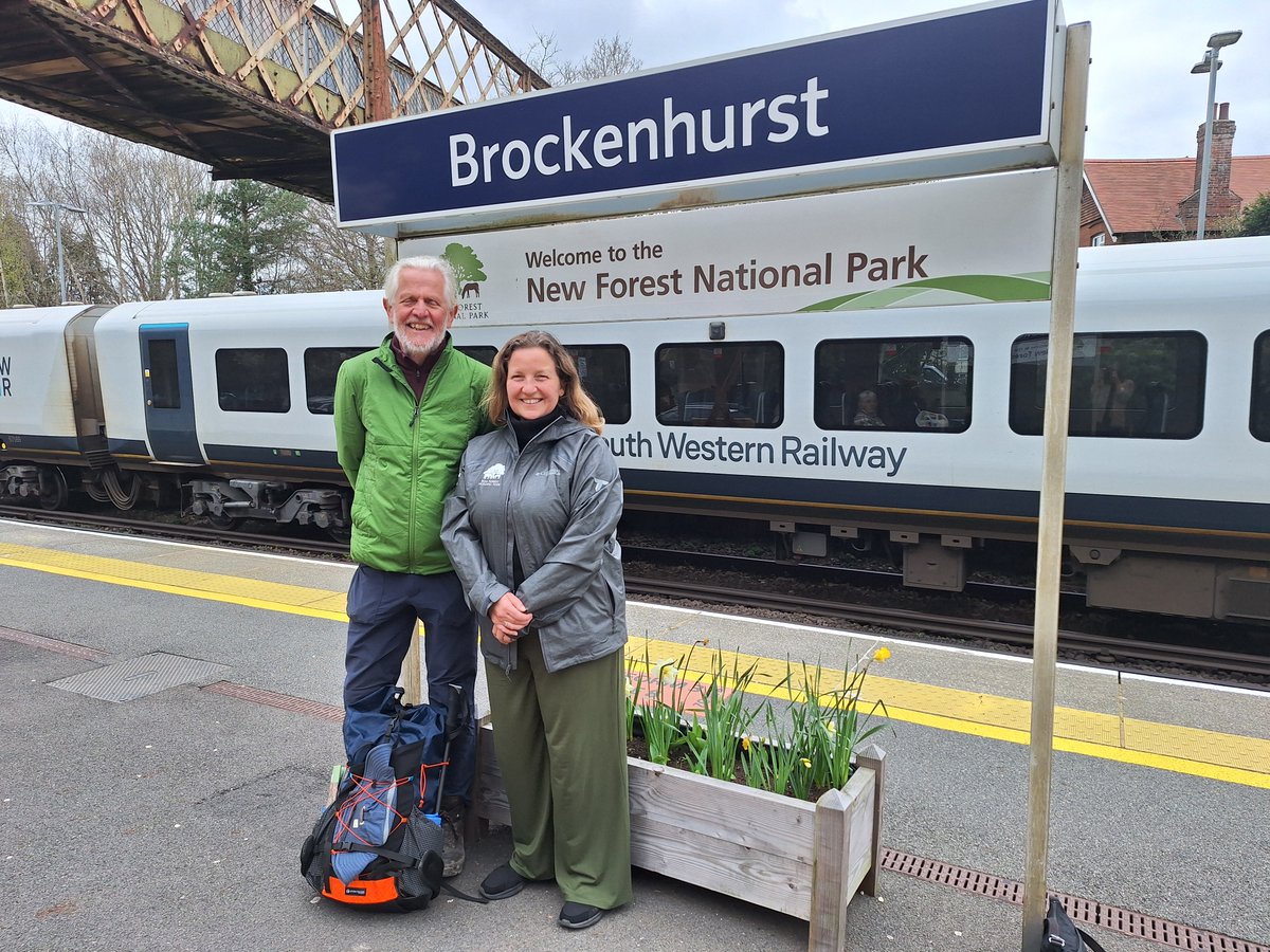 NewForestNPA's tweet photo. 👣 Our Chief Executive, Alison Barnes, had the pleasure of meeting seasoned walker John Scott as he passed through the New Forest on an extraordinary journey.

John is taking on the Slow Ways National Parks Challenge – a 2,300-mile walking route connecting all 15 of the UK’s National Parks, along with the world’s first National Park City, London.

Having set off on foot from Southampton that morning, John met Alison at Brockenhurst railway station to mark an impressive milestone – 450 miles into his journey. The New Forest is the third National Park he has visited so far, and his first time here. 
The challenge follows the Slow Ways National Parks Trail, part of a wider citizen-led initiative to create a walking network linking towns, cities and some of the UK’s most treasured landscapes.

John is undertaking the challenge as a personal milestone, aiming to complete the route over six months while taking time to fully experience the places he passes through.

Dan Raven-Ellis, Founder of Slow Ways, said, ‘Our National Parks are simply some of the best and most inspiring parts of the UK - so how wonderful to go on an adventure to join them all up! The Slow Ways National Parks Trail is being developed by dozens of volunteers from across the country, all helping to suggest and check its 253 route-legs that cover 3,719km (2,311 miles). With John being the first to attempt to walk the whole trail in one go, I hope lots of people will be inspired to follow in his footsteps.’

#NewForest #SlowWays #WalkingChallenge #NationalParks #UKTrails