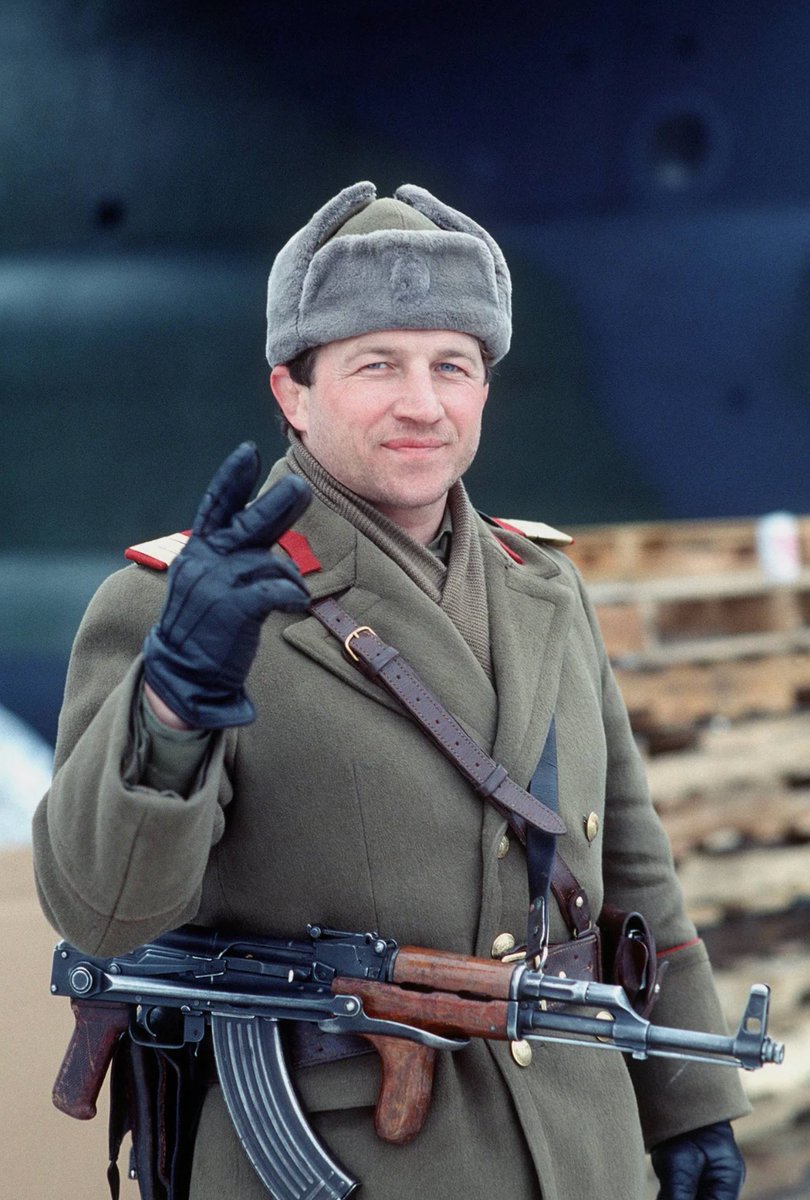 A Romanian soldier giving a sign of victory after the 1989 revolution, having removed the communist insignia from his headwear.