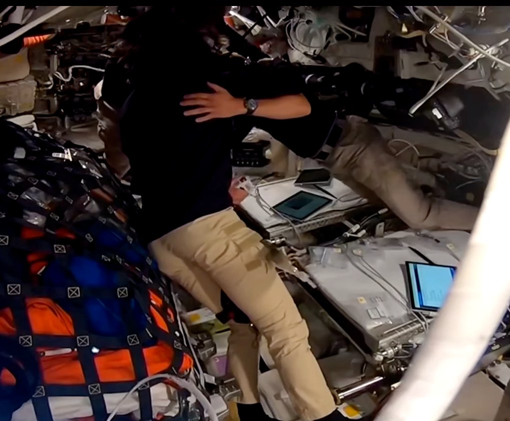 kate_tice's tweet image. Reid saying hi to his two daughters visiting Mission Control Houston (the bracelet is from them), just minutes before the Artemis II crew proposed to name a lunar crater after his late wife, Carroll.  
Cue Crew group hug and tears (there and here, too)  😭