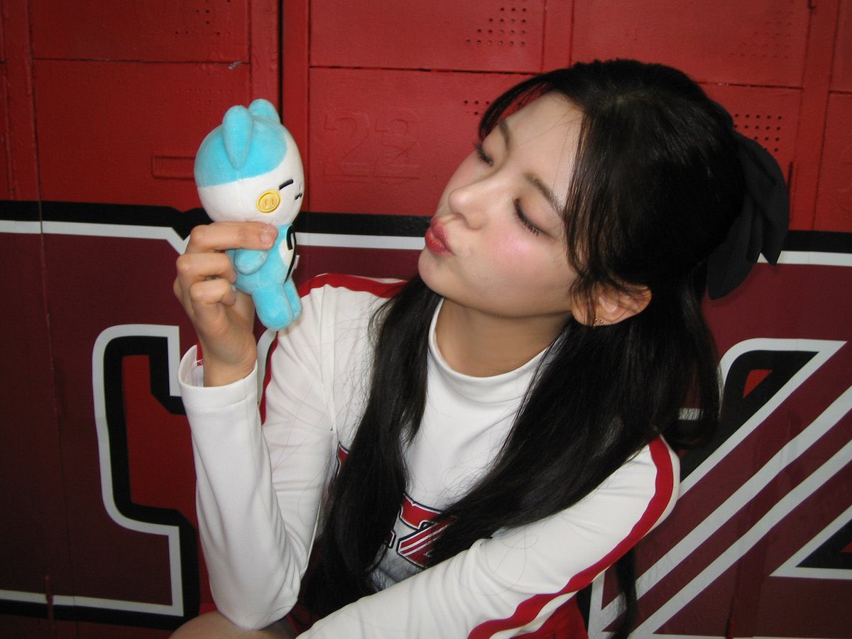 Jisuochoi's tweet photo. Hey, this picture is so cute, right? Look at my little plushie friend—matching my vibe, don’t you think? Winking and all! Hehe. This was such a fun moment. I had so much energy, and the cheerleader look? Totally loving it! Hope you guys are having an amazing day too. https://t.co/39l9lv60za