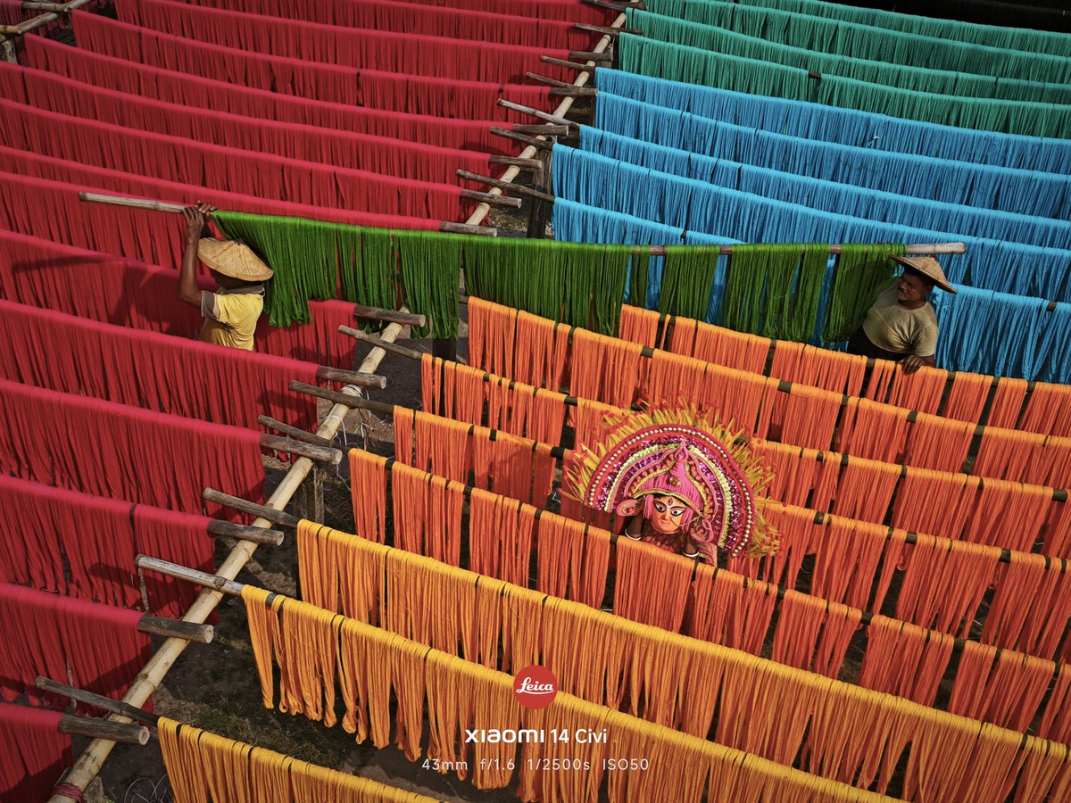 9thdec's tweet photo. “Threads of Shakti”

Amid rows of hand-dyed threads drying under the open sky, the face of Goddess Durga quietly emerges—symbolizing the inseparable bond between devotion and daily labor in Bengal. Captured on the Xiaomi 14 Civi, 
@Xiaomi @XiaomiIndia @NatGeoPhotos  @timesofindia https://t.co/2RLYHLP4Vm